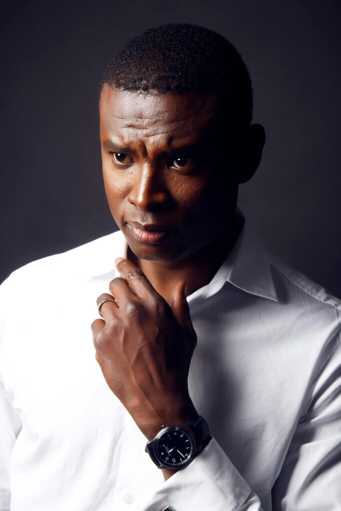 Portrait of a thoughtful man in a crisp white shirt with a serious expression.